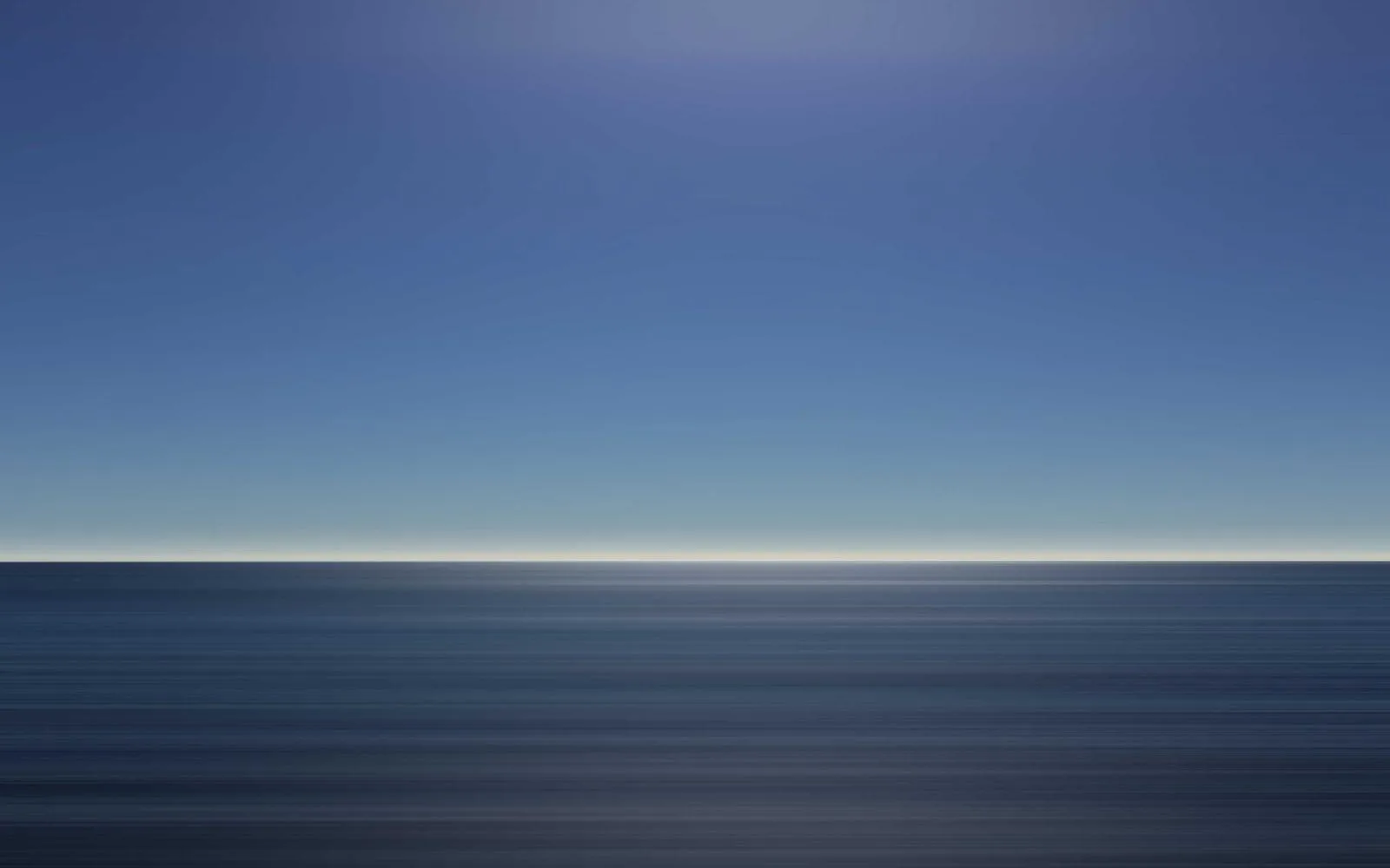An abstract, motion-blurred view of a blue sea horizon